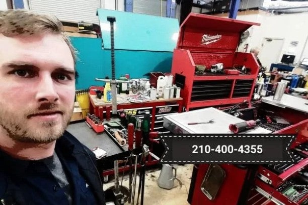 A mechanic taking a picture of his workshop